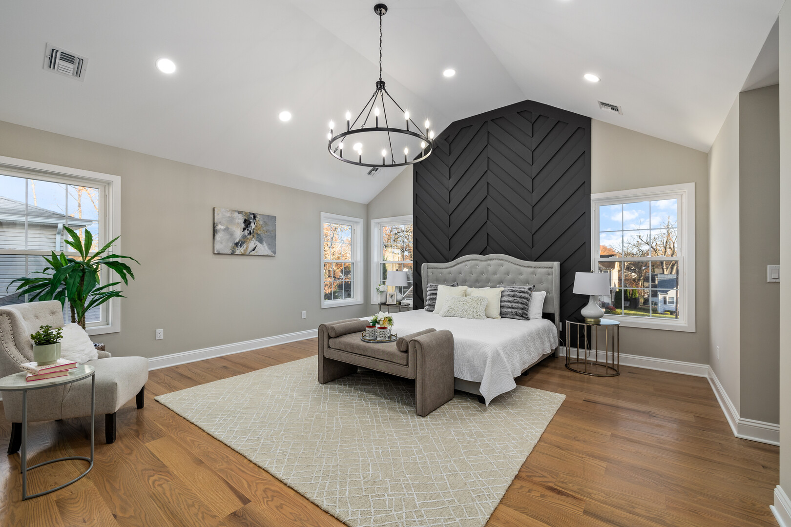 real estate staging of a master bedroom with luxurious bedding and spacious atmosphere